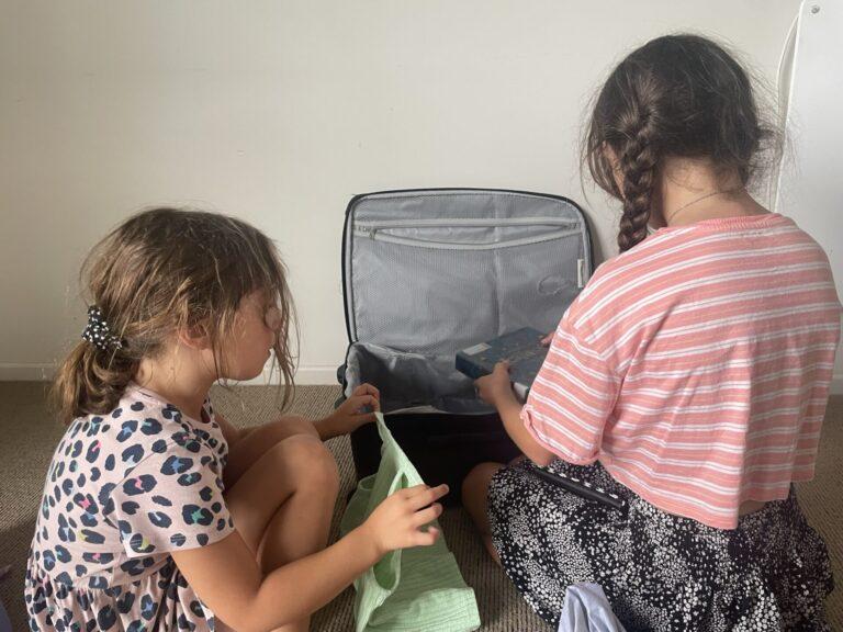 Kids packing a suitcase